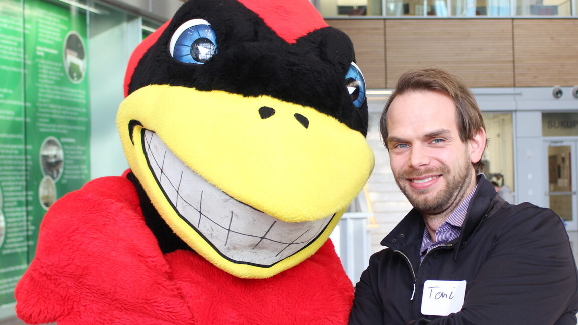 alum with cy the mascot