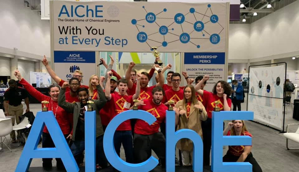 students with AIChE sign